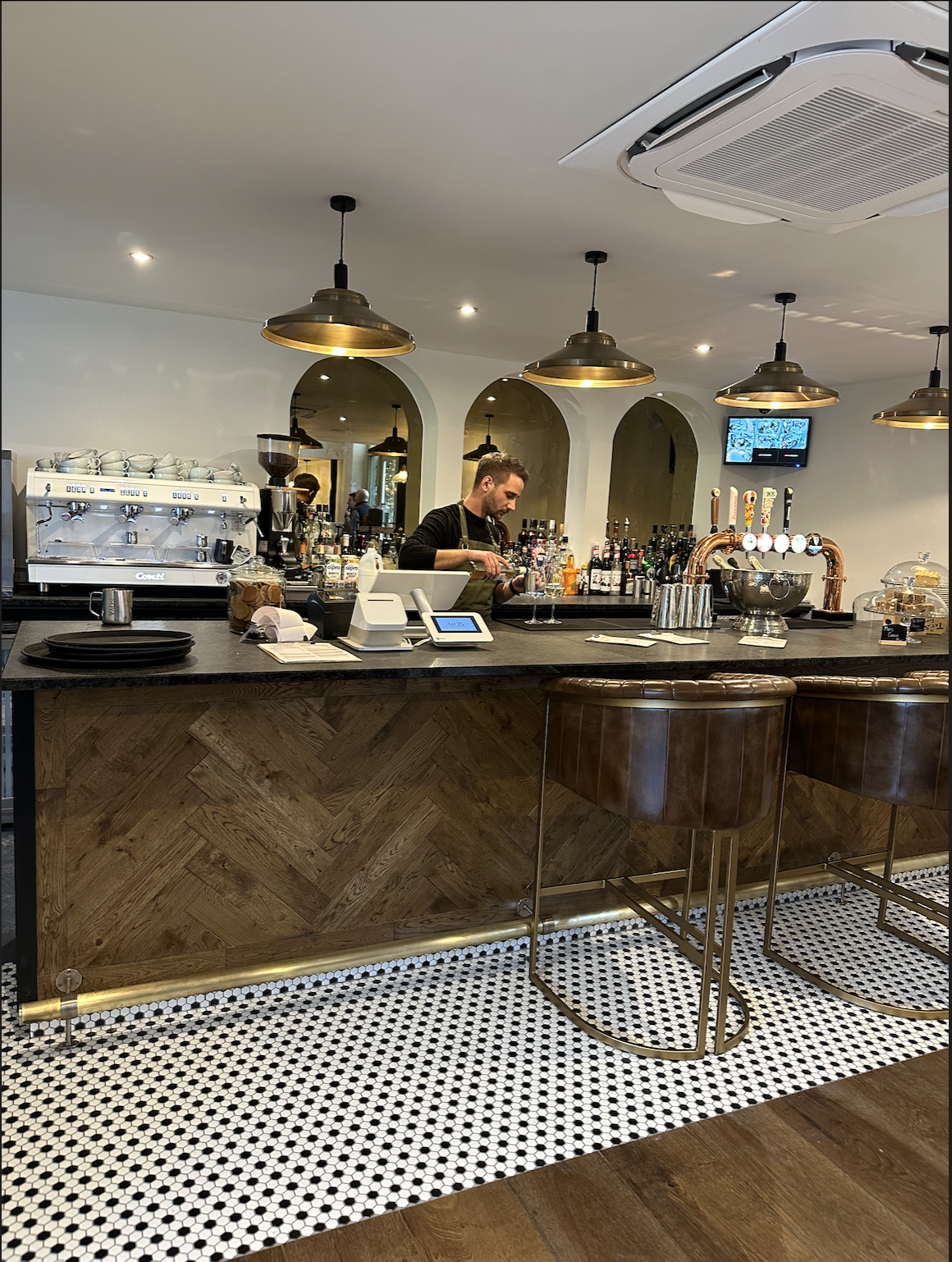 Bespoke commercial bar fit-out with herringbone oak panelling in Newmarket by Cromwell Interiors